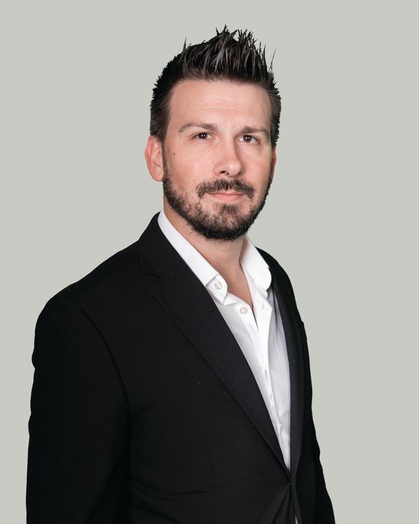 DJ Stephen Craig, suit, on grey